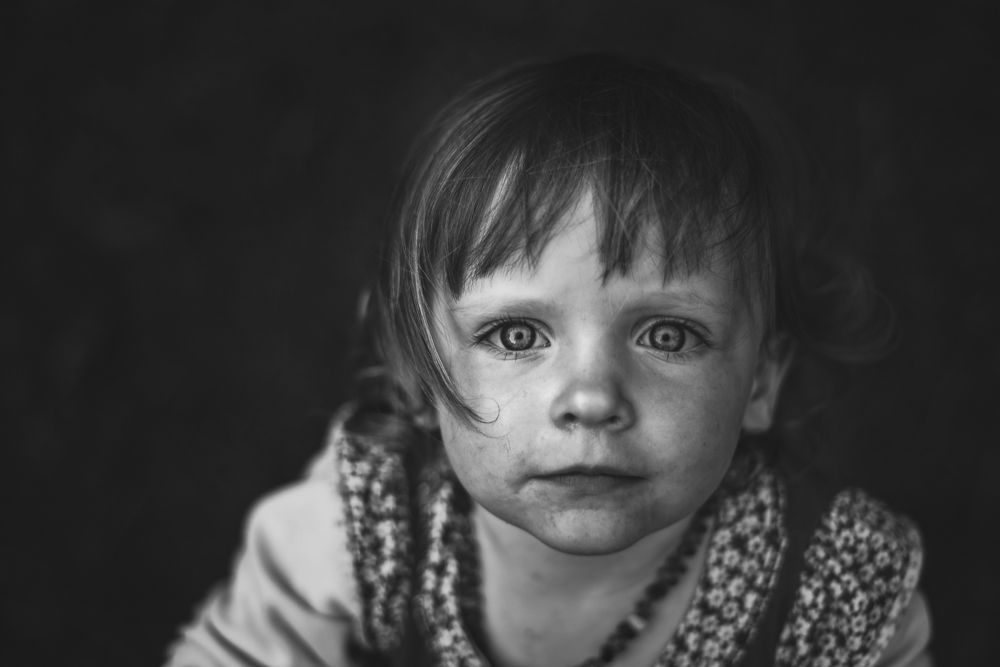 A young girl looking up into the camera